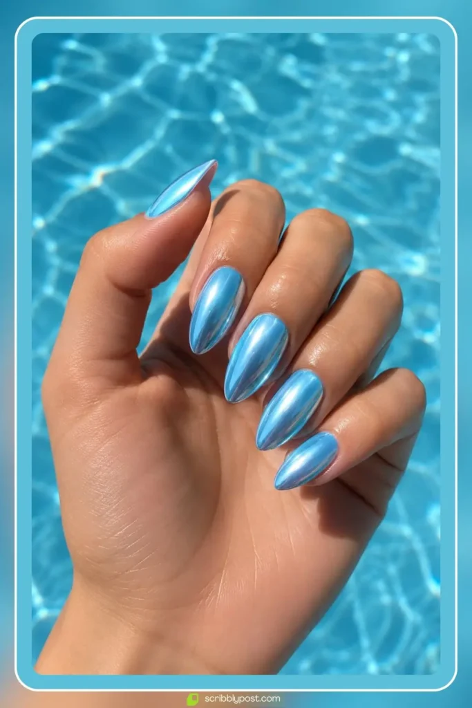 Baby blue chrome nails with icy mirror finish on almond shaped nails