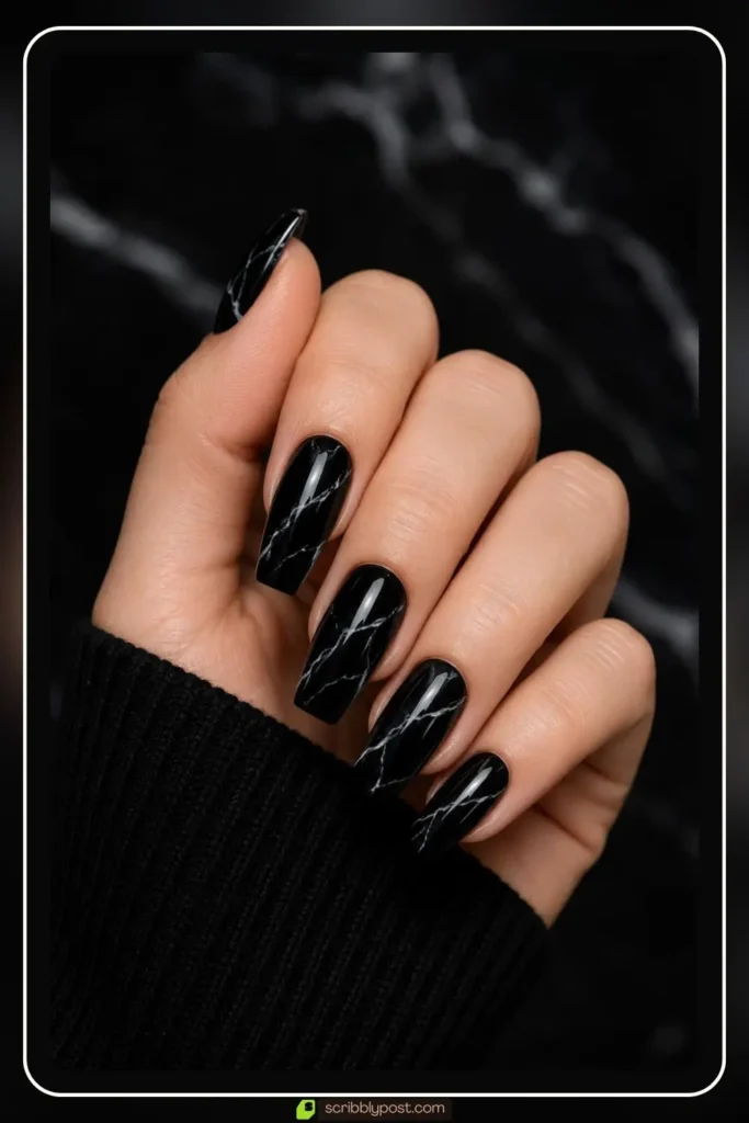 onyx marble nails with silver veining on a deep black gel base on oval shape