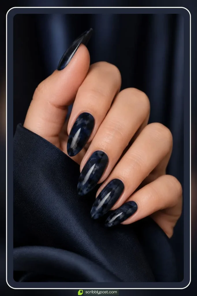 Blue tortoise shell nails with navy base and black speckle pattern