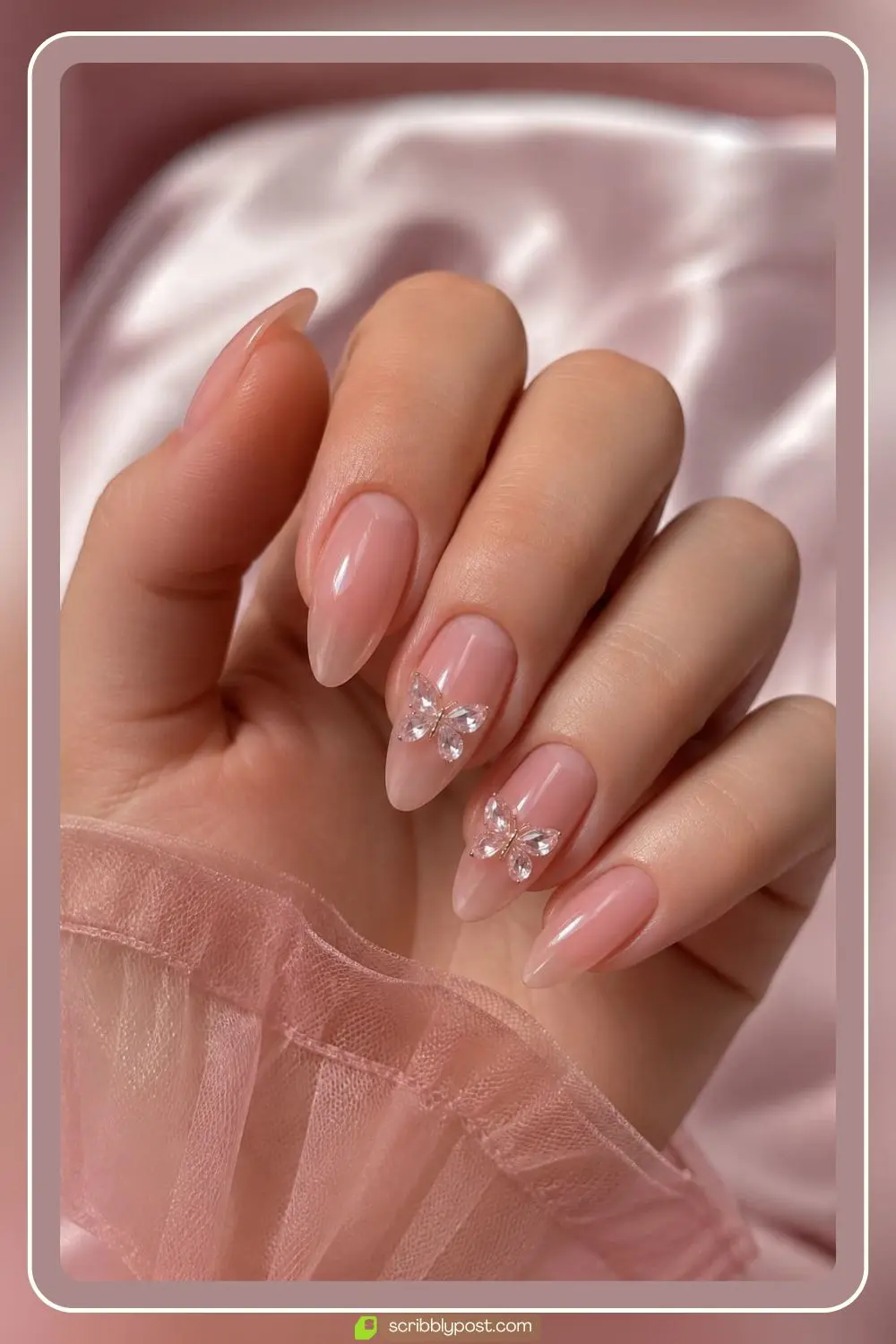 Sheer pink nails with small crystal butterflies on two accent nails