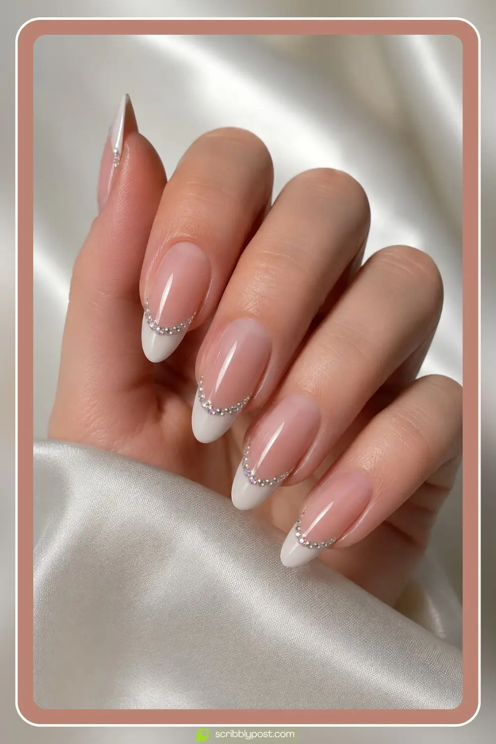 French manicure with small rhinestones lining the smile line on almond nails