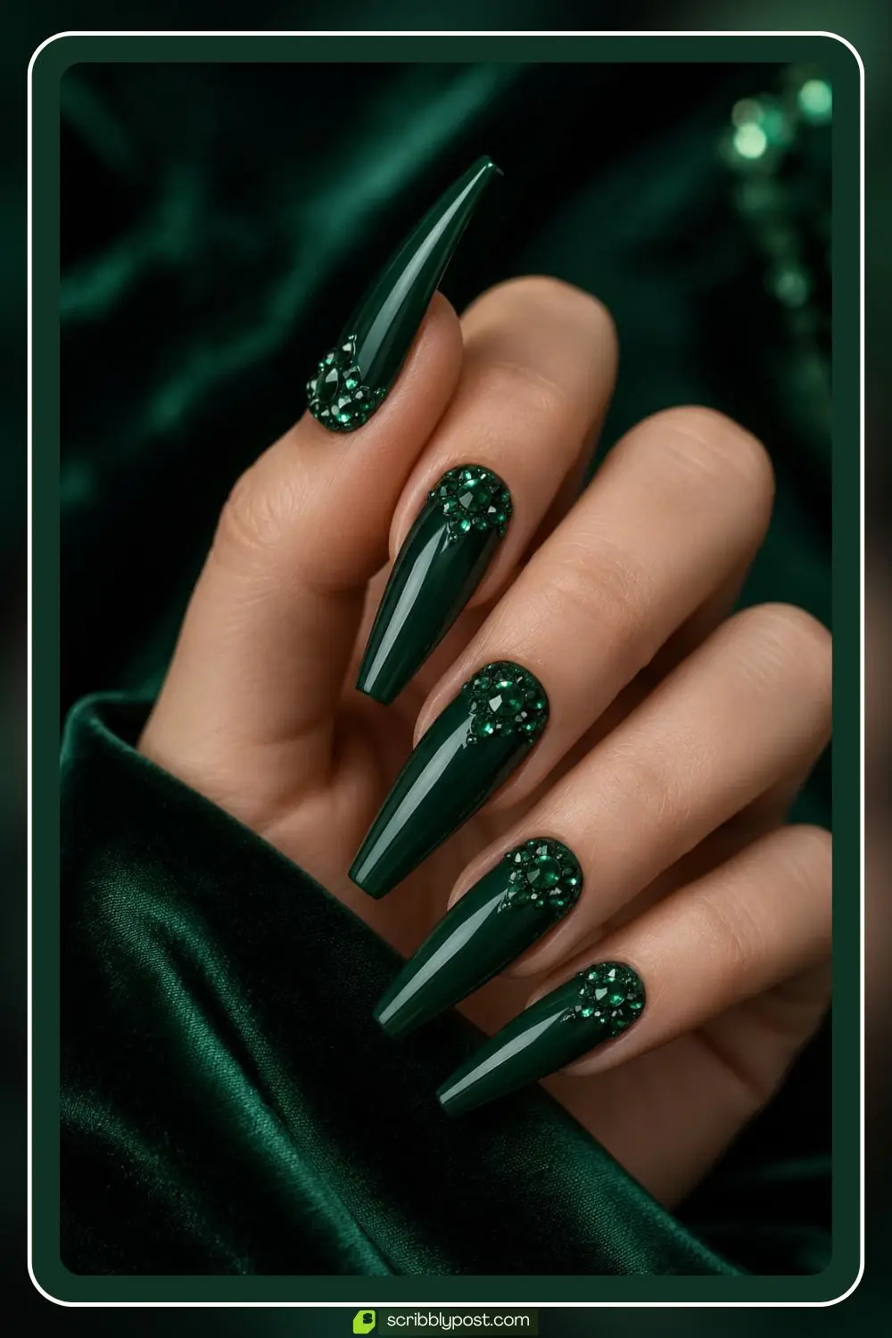 Dark green nails with emerald colored rhinestones in cluster arrangements