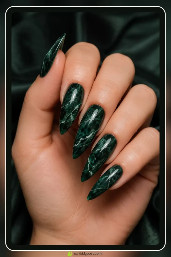 Emerald green stone swirl marble nails on coffin shape with white veining on deep green gel
