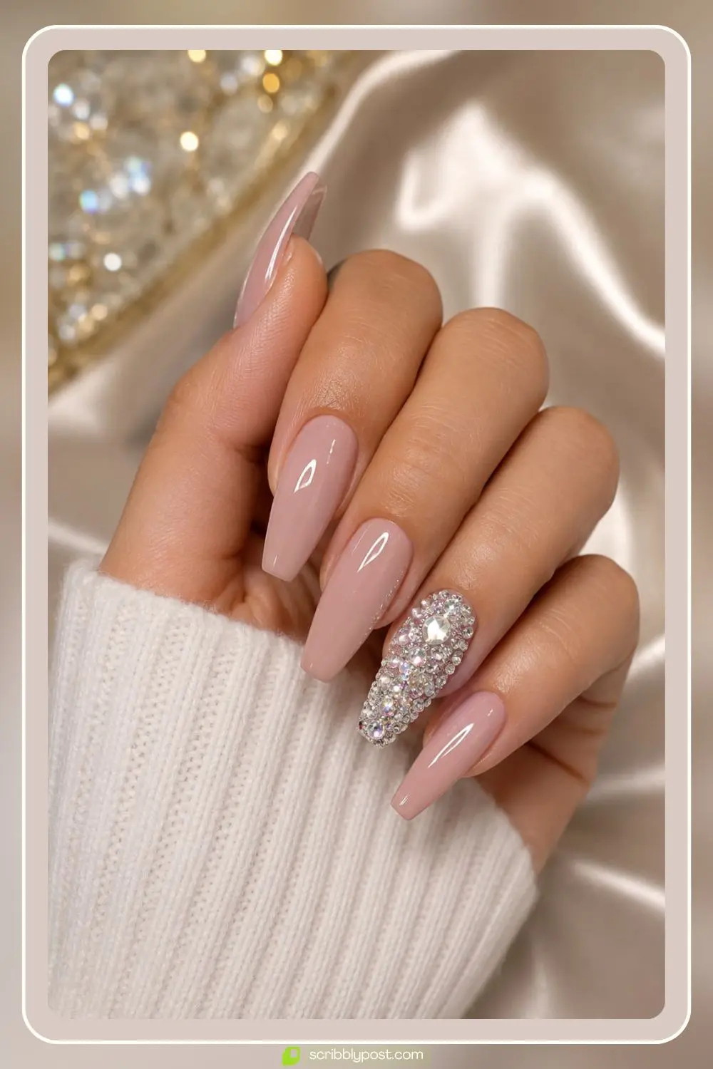 Glittering fully crystal covered accent nail beside glossy nude nails