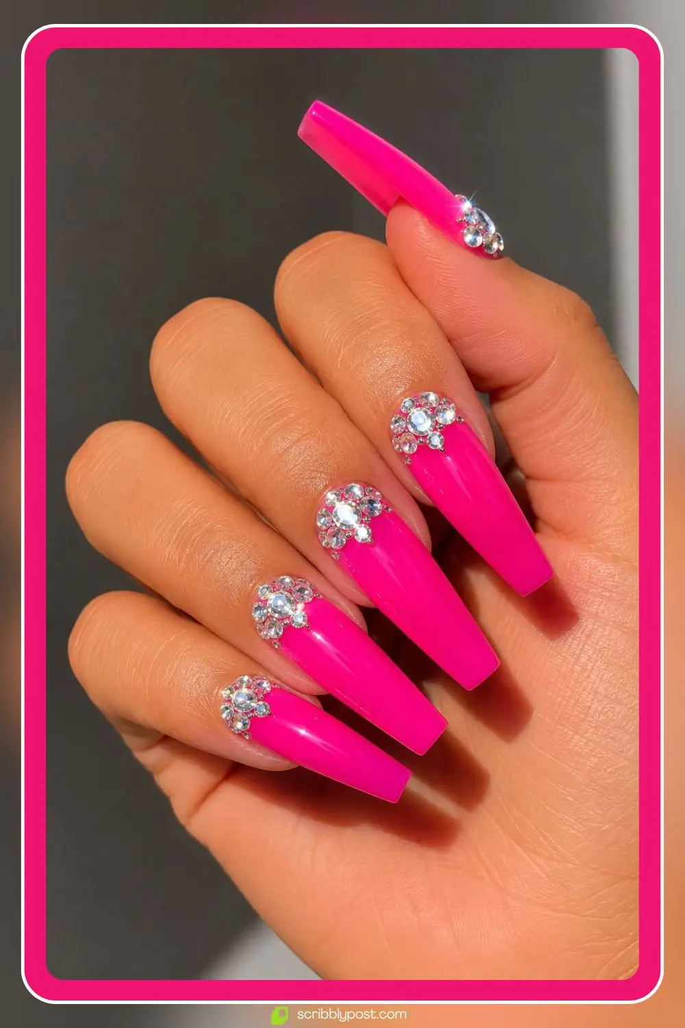 Hot pink rhinestone nails with clear crystal clusters on long coffin nails