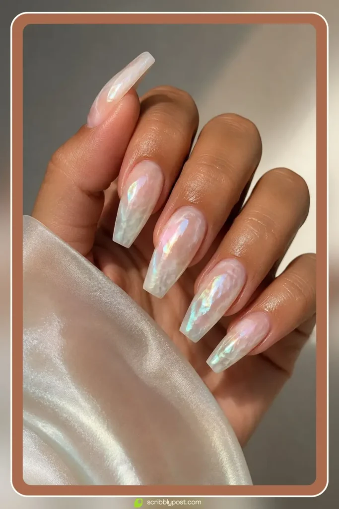 Nails with mother of pearl marble effect in shifting white, pink, and green iridescence