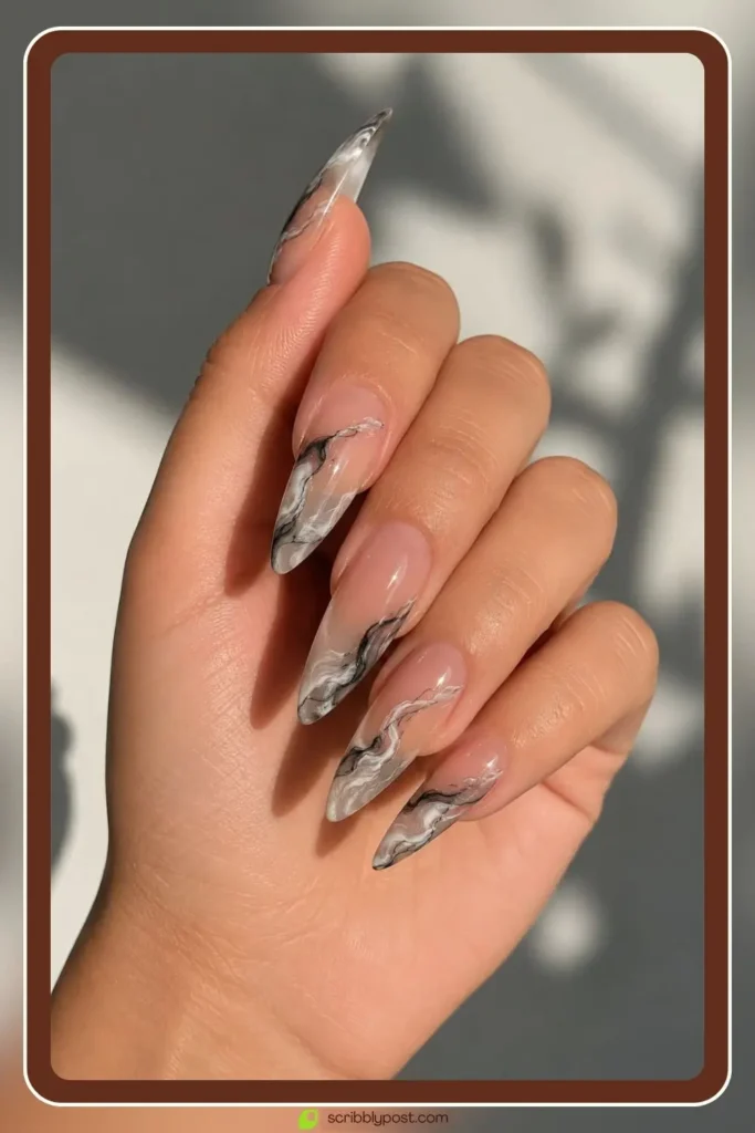 Negative space marble nails on short oval with clear gel base and marble veining leaving skin visible