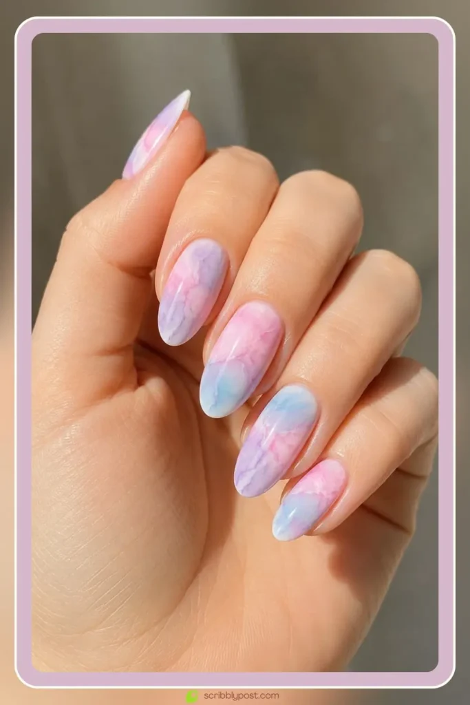 Pastel watercolor marble nails on short oval shape with soft blended pastel shades and sheer finish