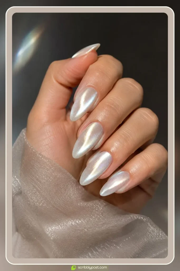 Pearl cat eye nails with a magnetic band of light moving across a shimmery white base