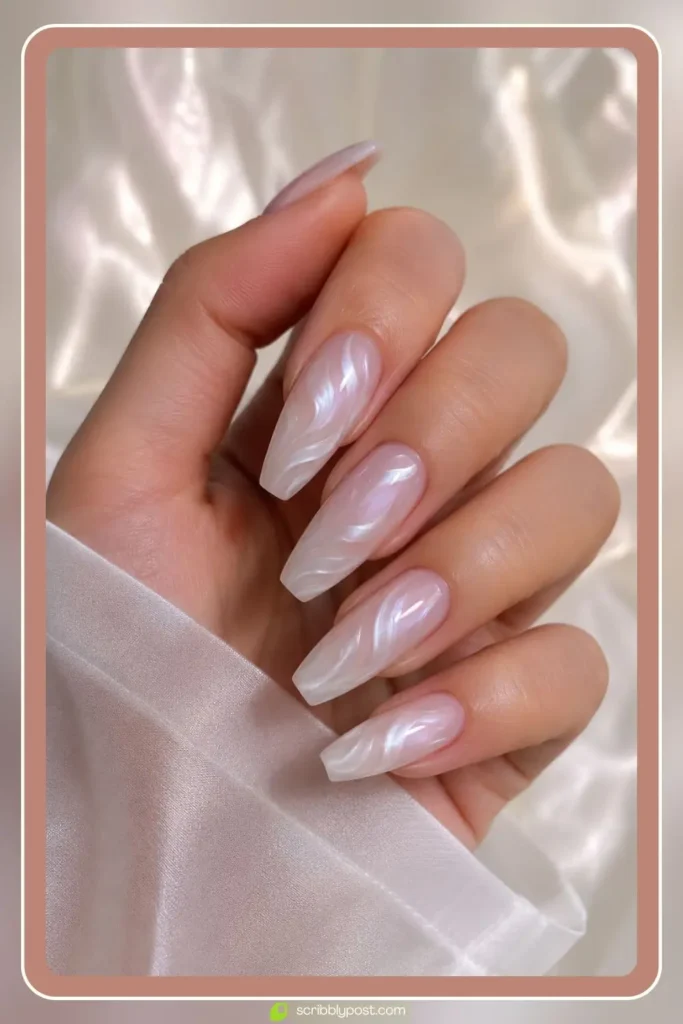 Milky nails with hand painted pearl white swirls curving across each nail