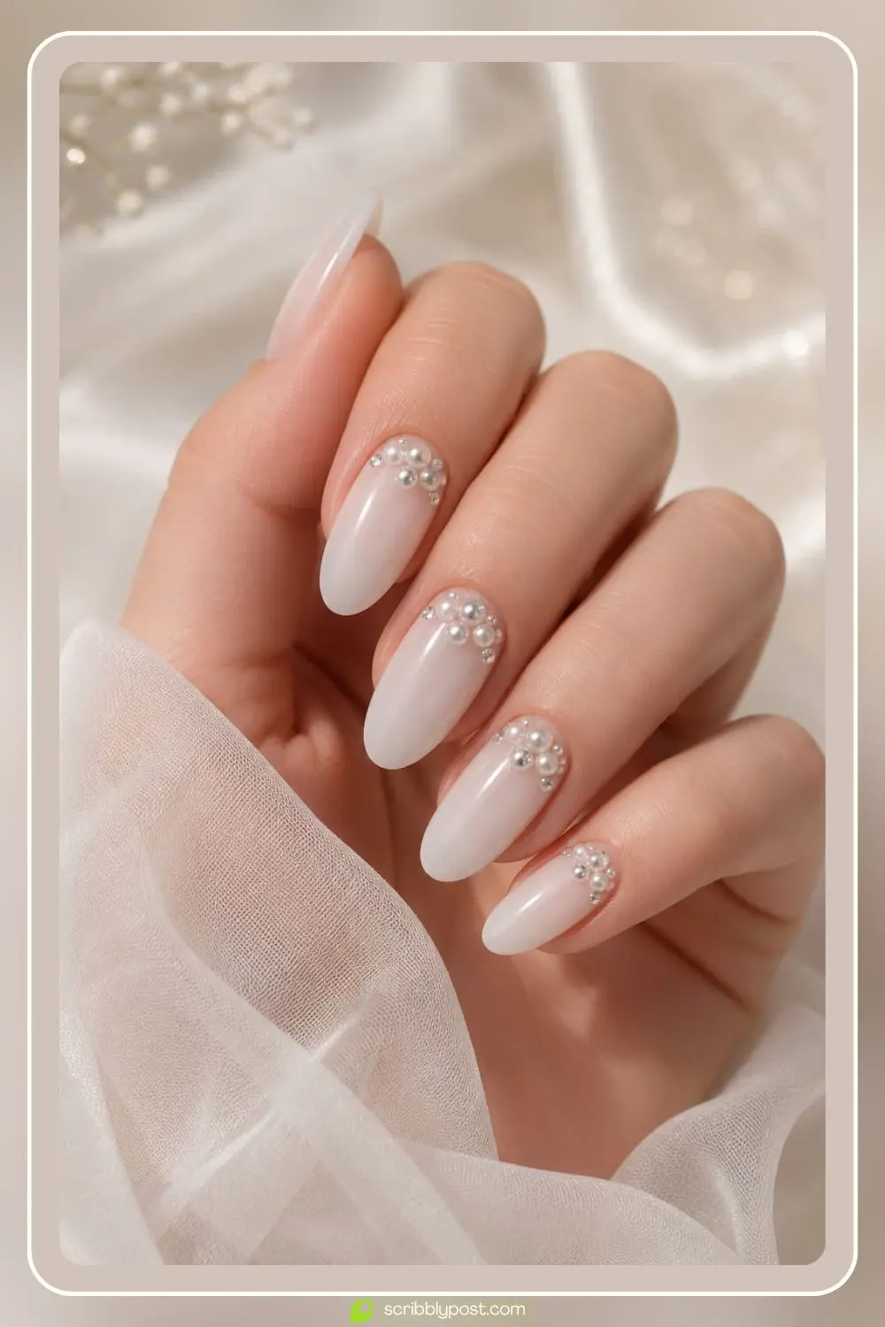 Milky nails mixing small pearls and rhinestones in clusters near the cuticle