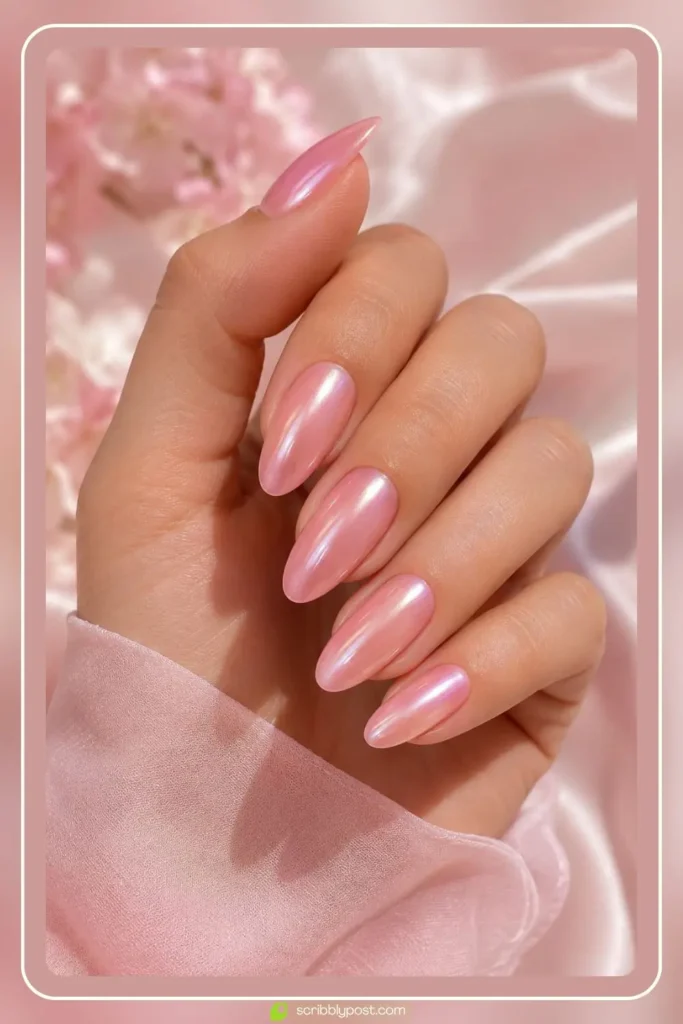 Soft pink pearl nails with rosy iridescent shimmer on almond shaped nails