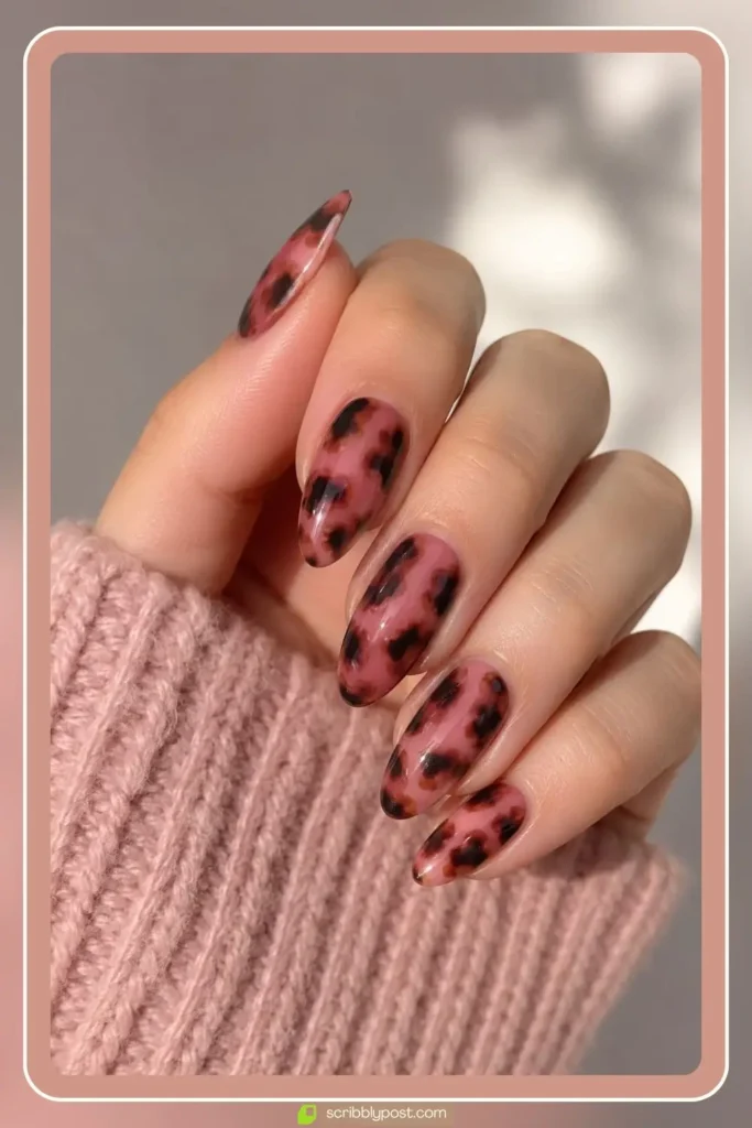 Pink tortoise shell nails with rosy base and brown speckle pattern on almond nails
