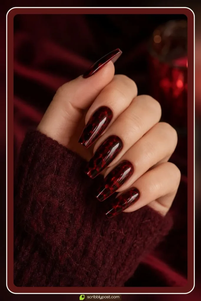 Red tortoise shell nails with cherry base and dark speckles on coffin nails