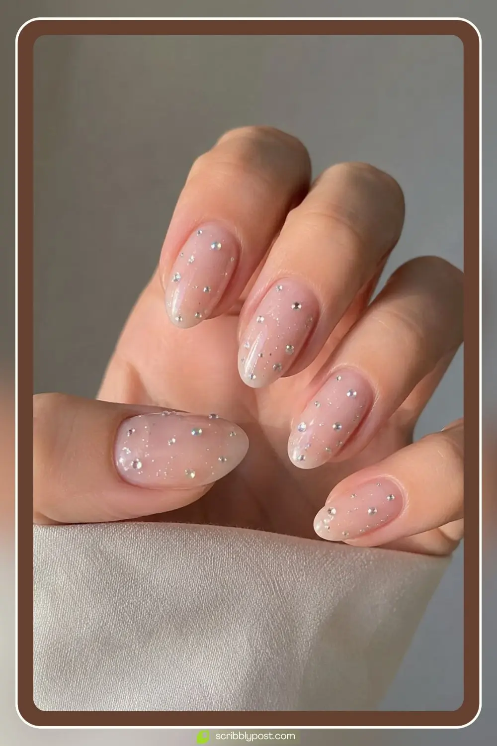 Sheer nails with tiny rhinestones scattered like stars across each nail