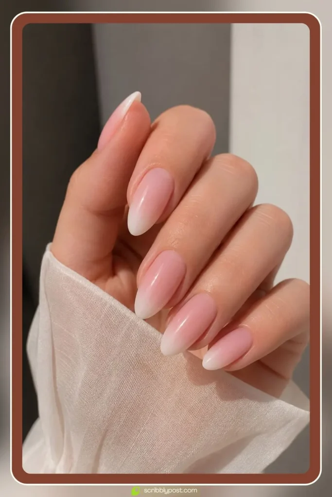 Soft pink to white ombre clean girl nails on short oval shape with glassy finish