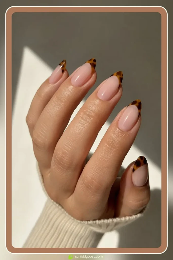 Nude nails with tortoise shell french tips on almond shaped nails