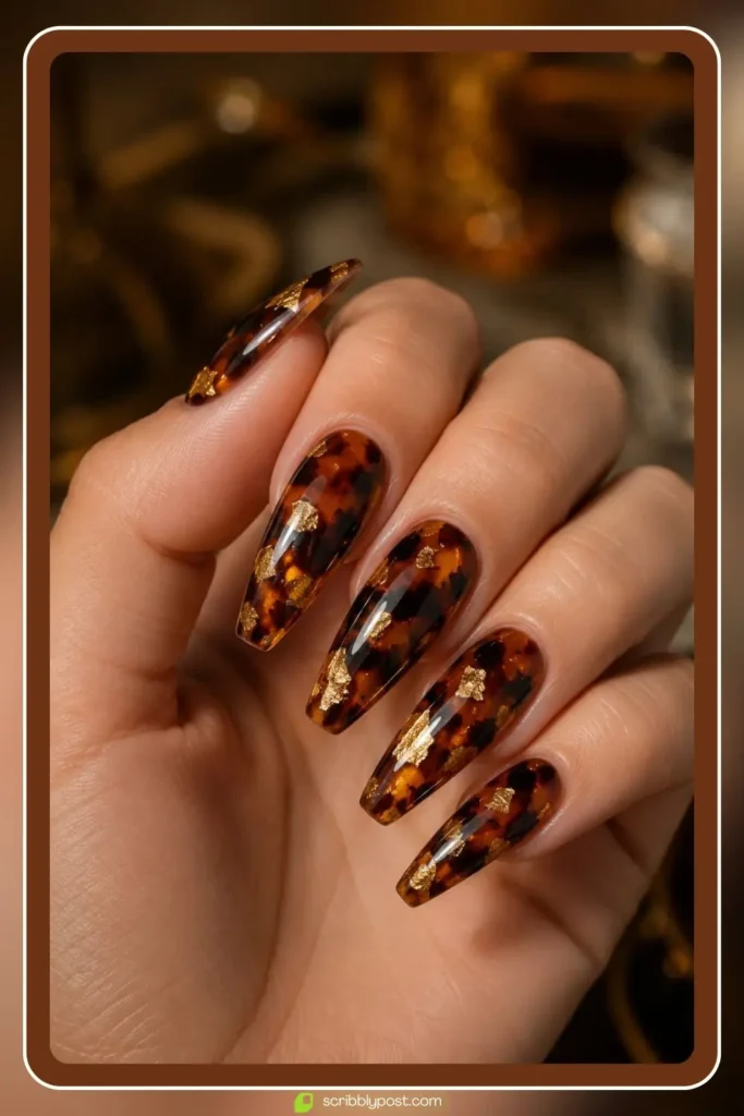 Tortoise shell nails with gold foil flakes accenting the amber pattern