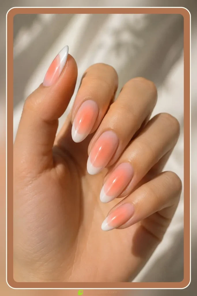 Peach aura glow with white french tips on almond nails