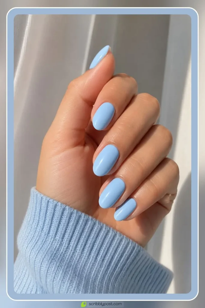 Baby blue nails in soft powdery solid on short almond shape