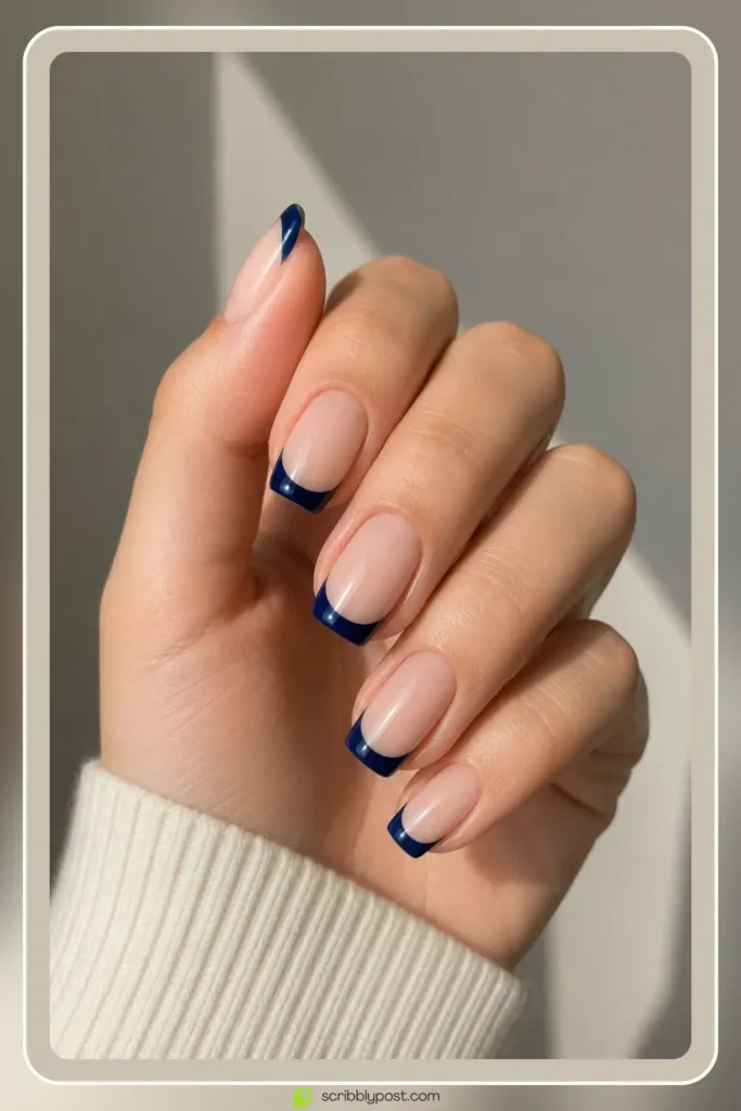 Blue french tip nails with navy tips on nude base