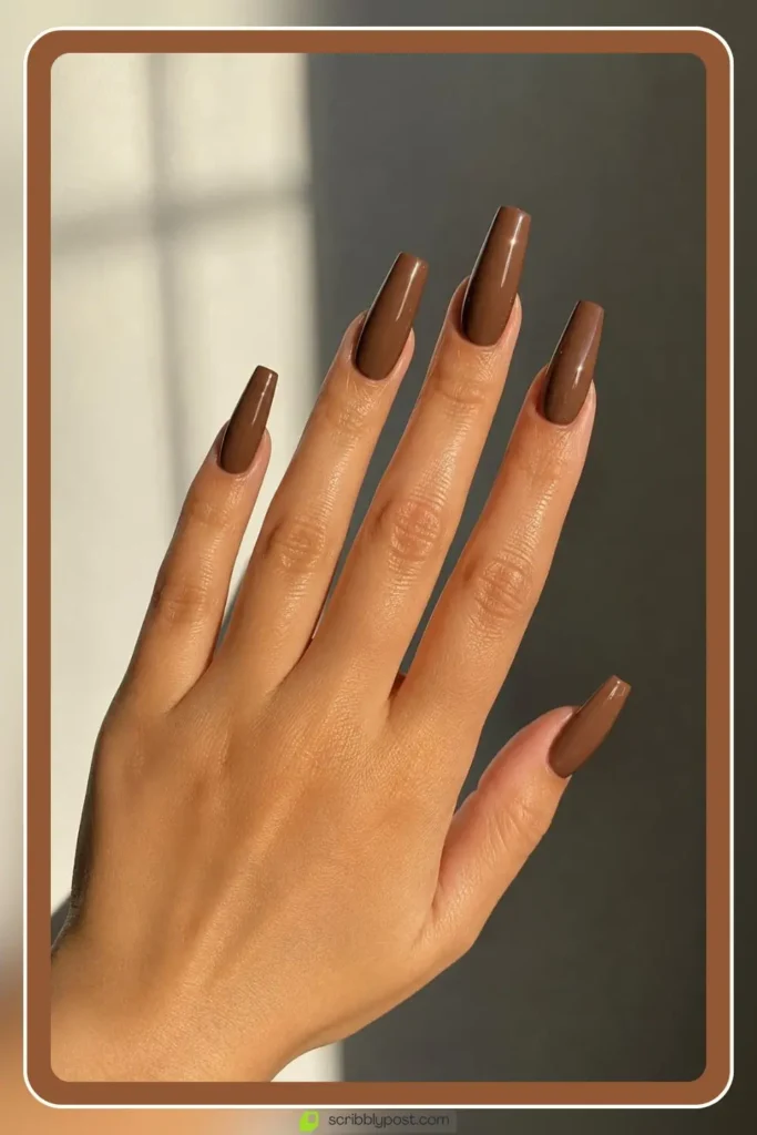 Long brown acrylic nails in sculpted coffin shape