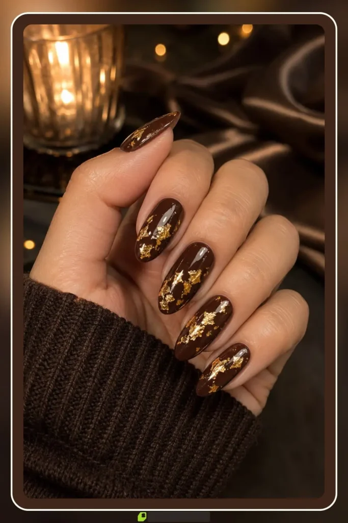 Brown nails with gold foil flakes on chocolate base