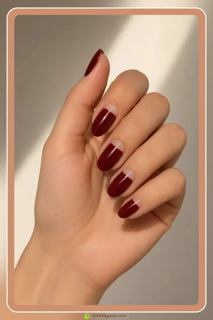 Burgundy half moon nails with bare crescent at the cuticle