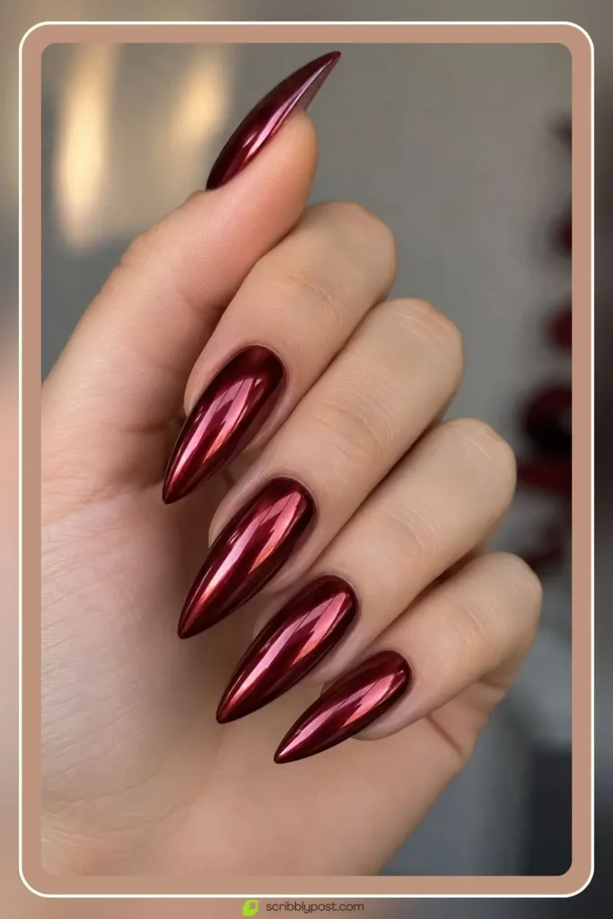 Burgundy chrome nails with mirror cherry glaze on long stiletto shape