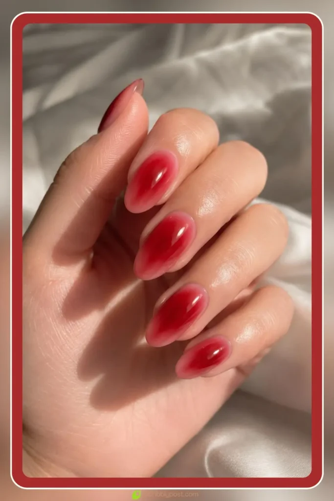 Cherry red aura with deep crimson core on oval nails