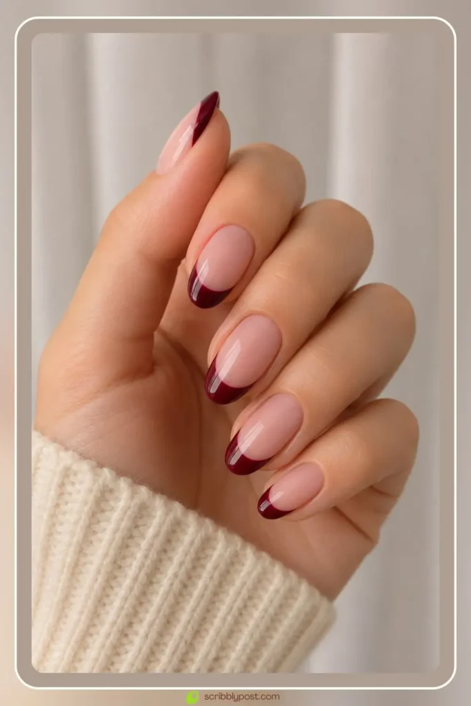 Wine burgundy french tip nails on short almond shape with nude base