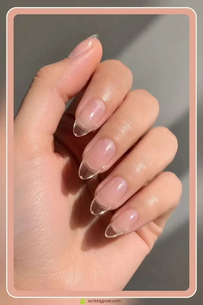 Clear jelly nails with glass-like transparent shine on almond shape