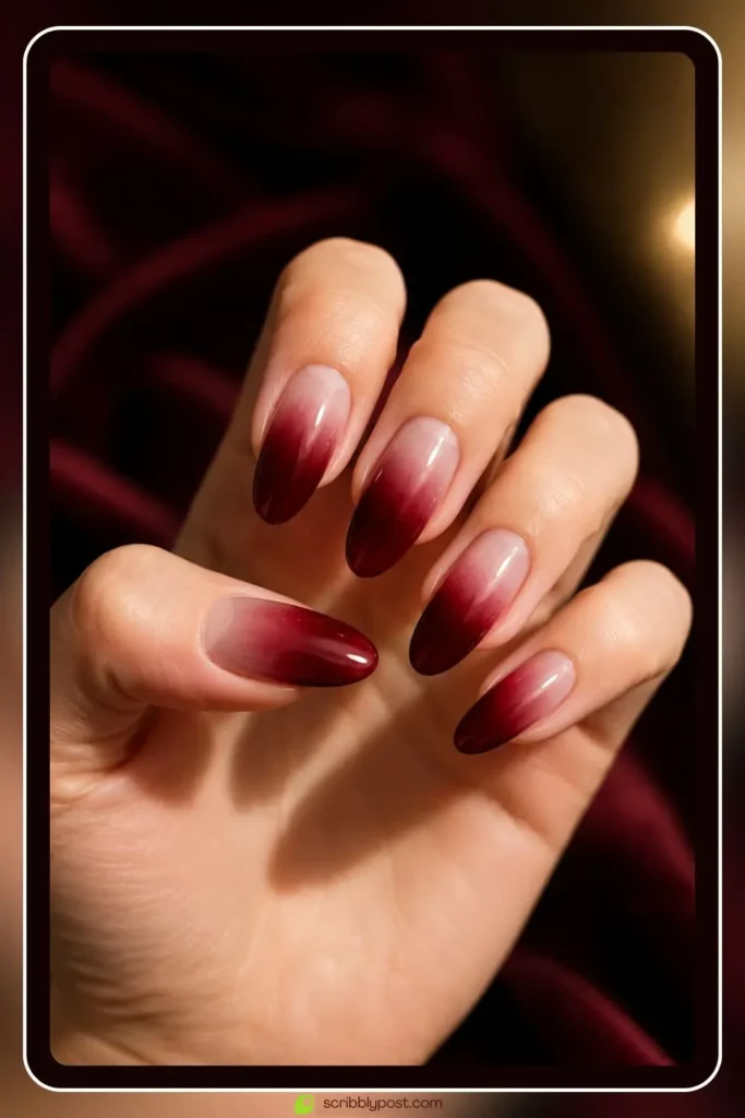 Burgundy dark red ombre nails fading to sheer on long oval shape