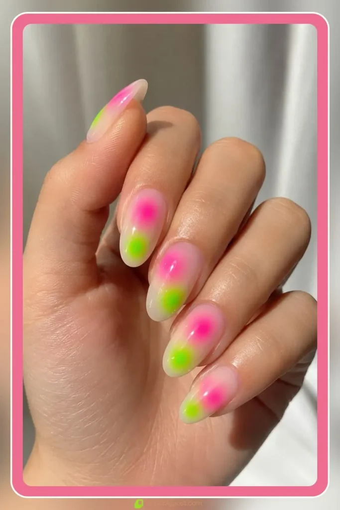 Two neon aura dots per nail on sheer base with pink and green glow