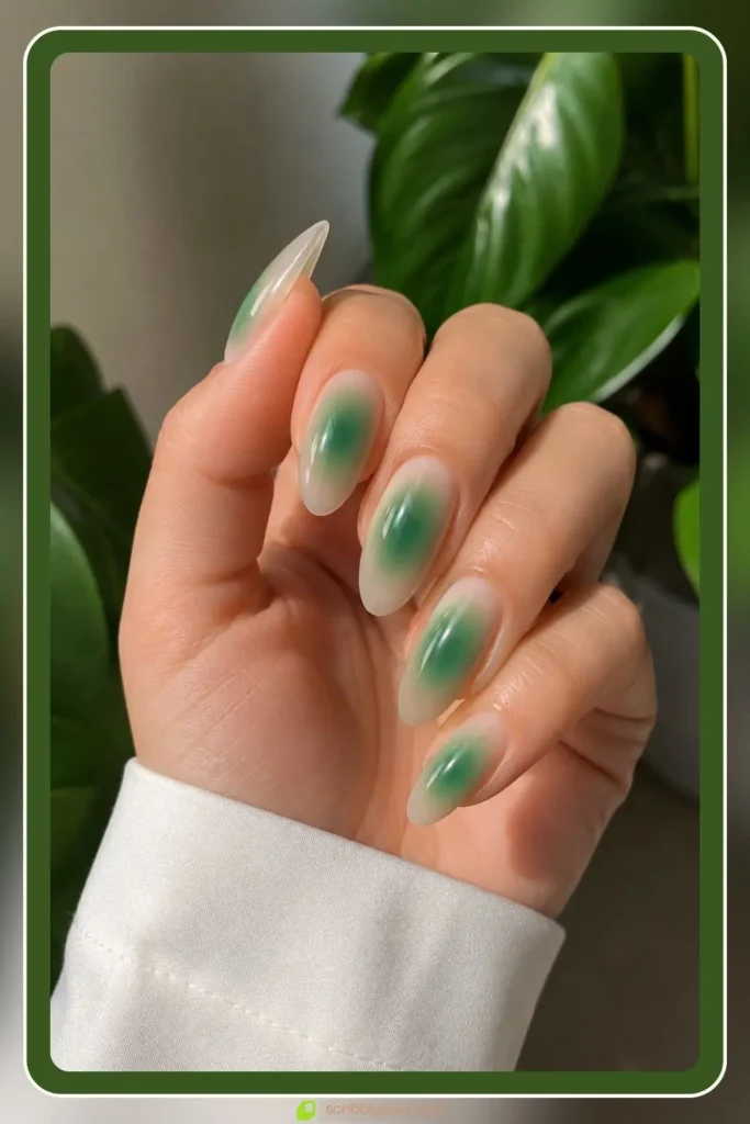 Emerald green aura glow centered on sheer nude almond nails