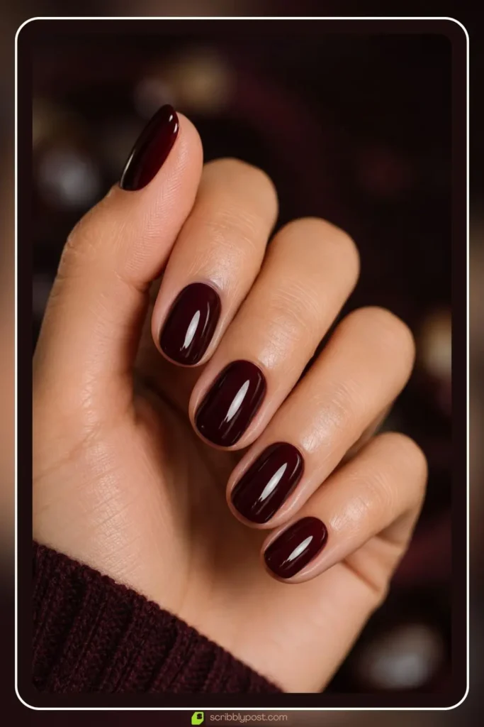 Deep glossy oxblood burgundy nails on short round natural shape