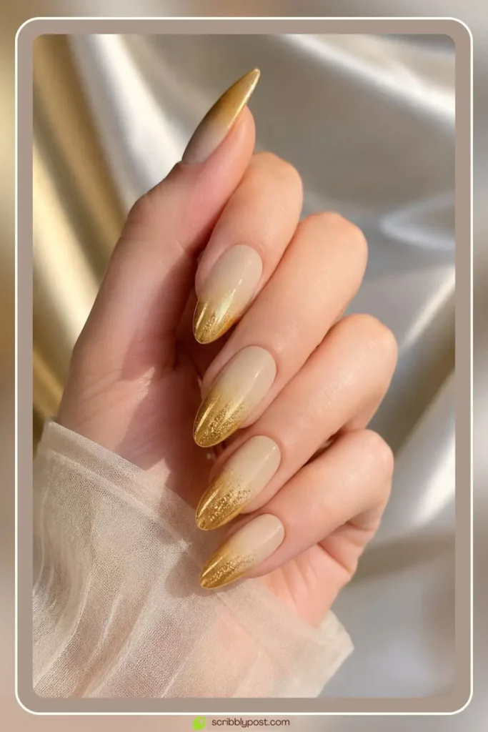 Gold ombre nails fading from warm cream to metallic gold