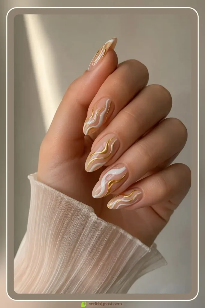 Gold and white swirl nails with abstract lines on sheer base