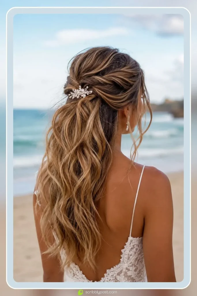 Half-up half-down beach wedding hairstyle with loose twist and pearl hair comb