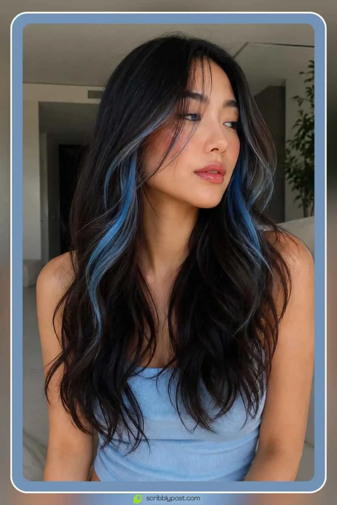 Icy blue accent hair color pieces on long dark hair