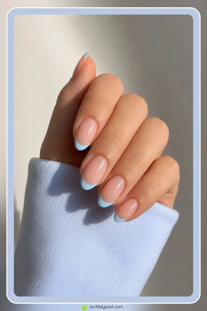 Light blue french tip nails on sheer nude base