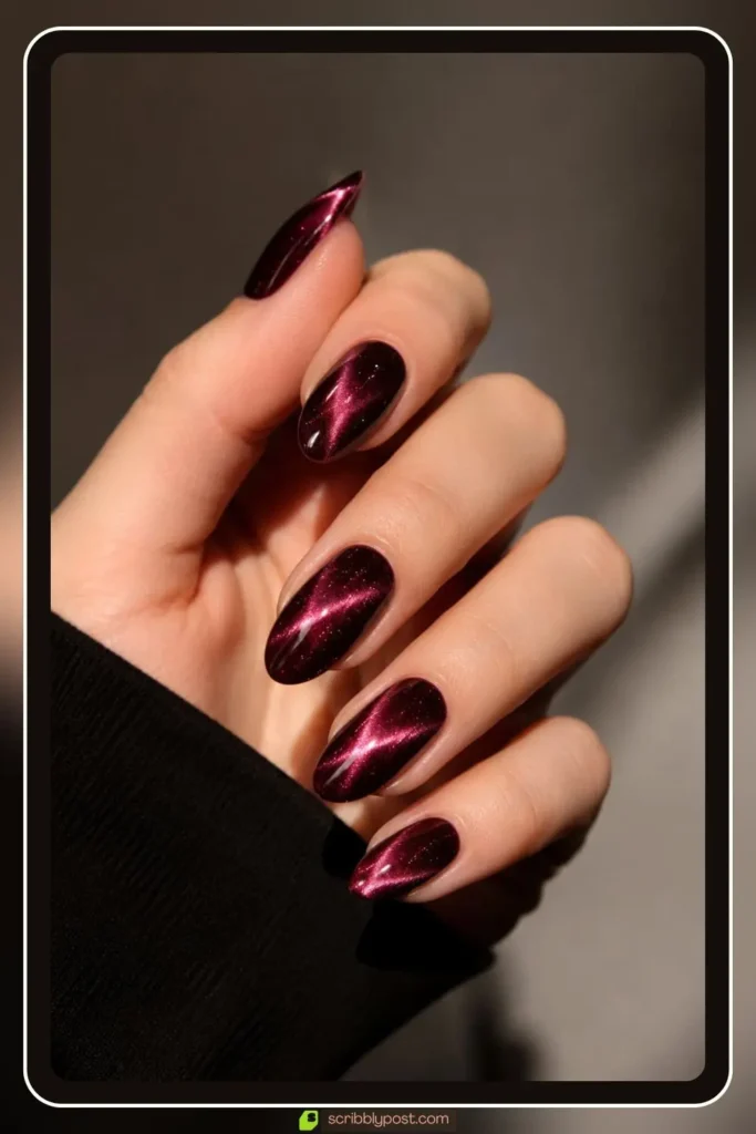 Burgundy cat eye nails with magnetic shimmer stripe on almond shape