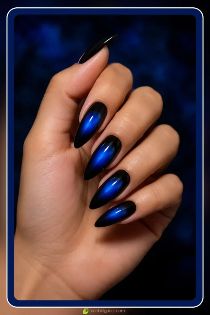 Black base nails with electric blue aura glow in the center