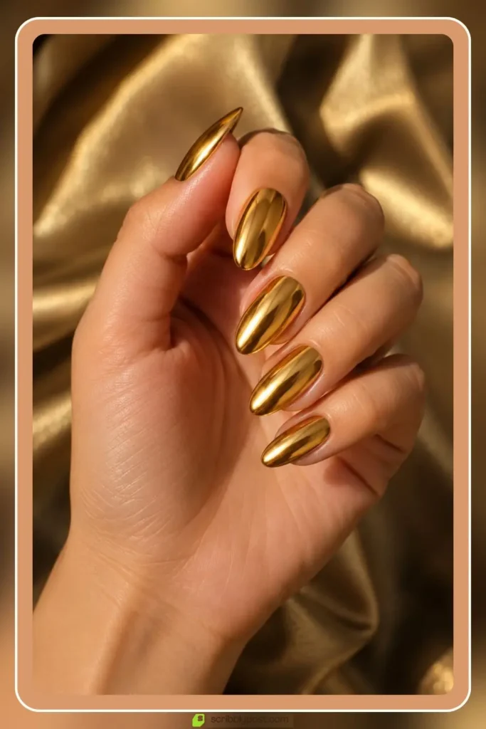 Mirror gold chrome nails with liquid metal shine on oval shape