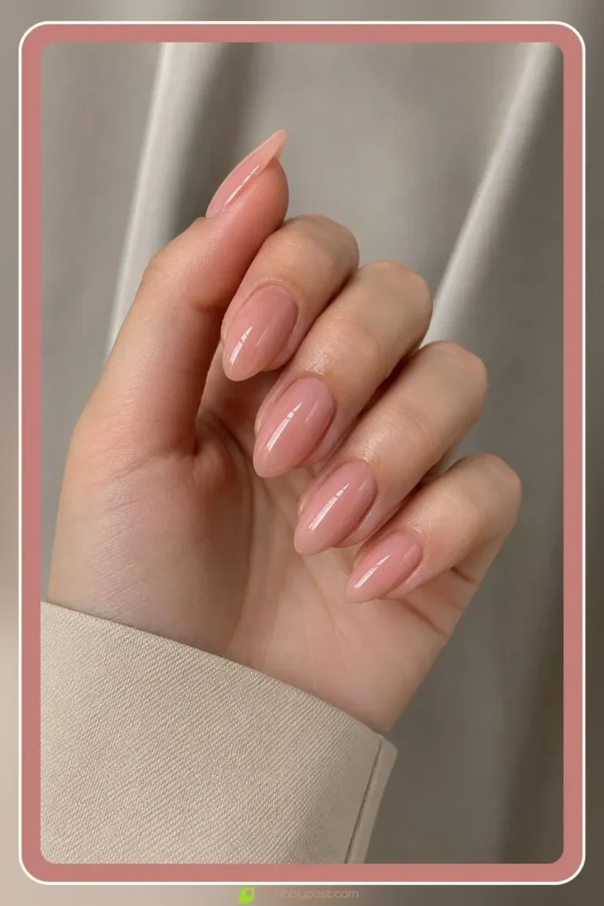Nude pink nails in soft rose beige on almond shape