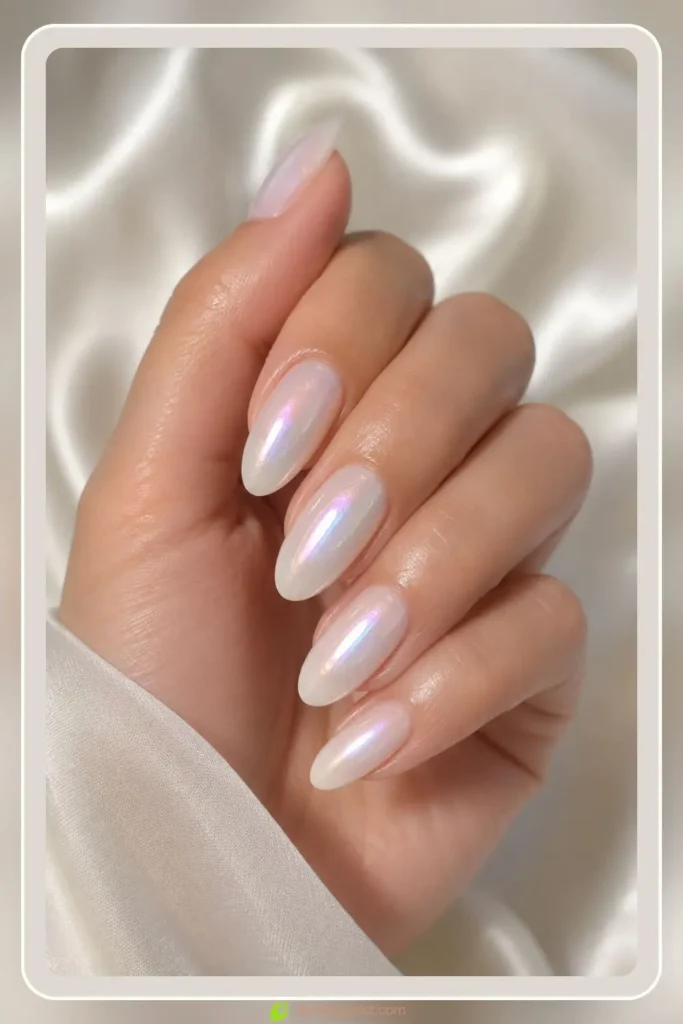 Pearl white aura nails with aurora shimmer on almond shape