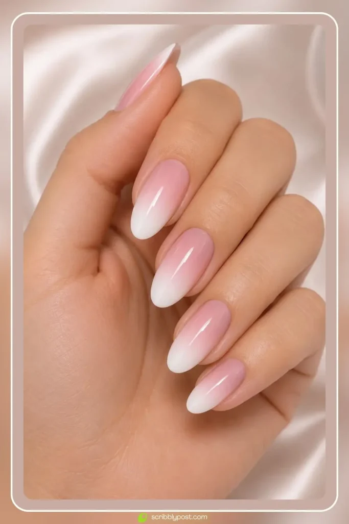 Pink and white ombre nails in soft baby boomer fade