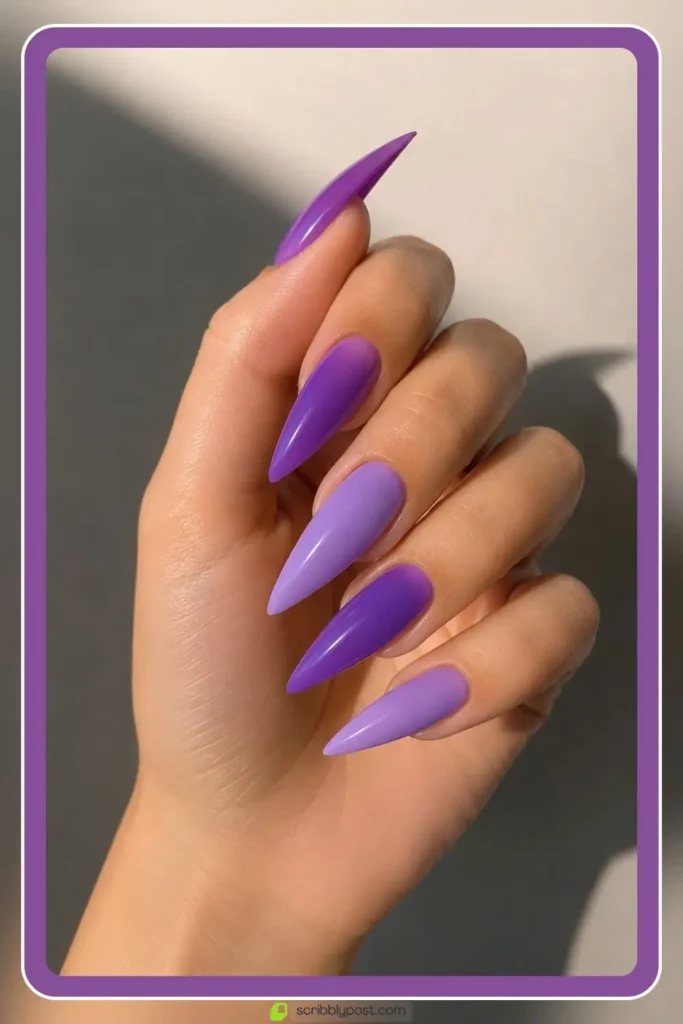 Long purple acrylic nails in sculpted stiletto shape