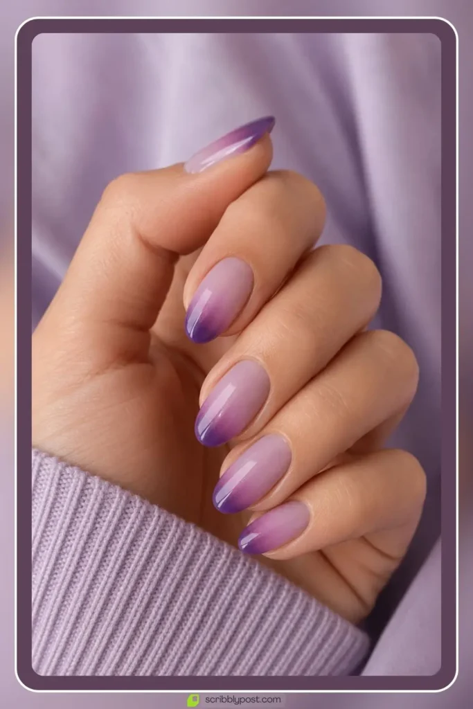 Purple ombre nails fading from plum to sheer lilac