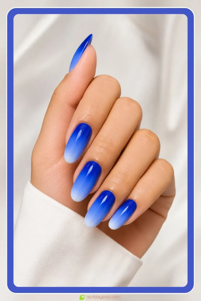 Bright royal blue fading to pale tip royal blue ombre nails statement